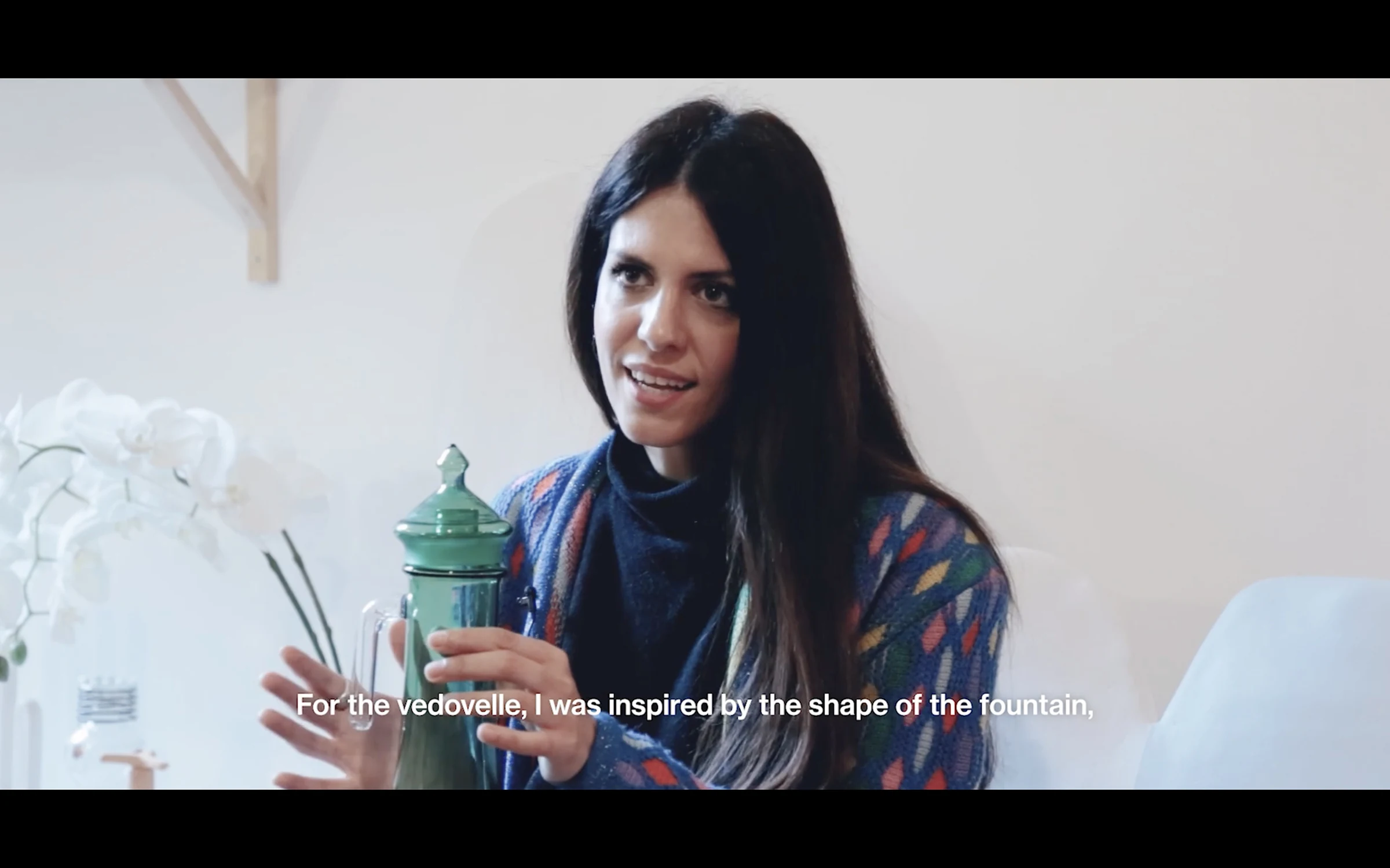 A designer in her studio, describing how a fountain's shape inspired her work