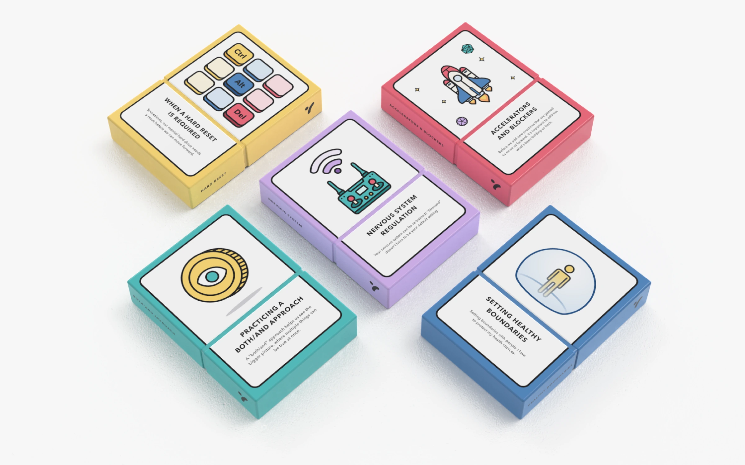 Boxed card decks in yellow, red, teal, and purple, each with its own illustrated cover