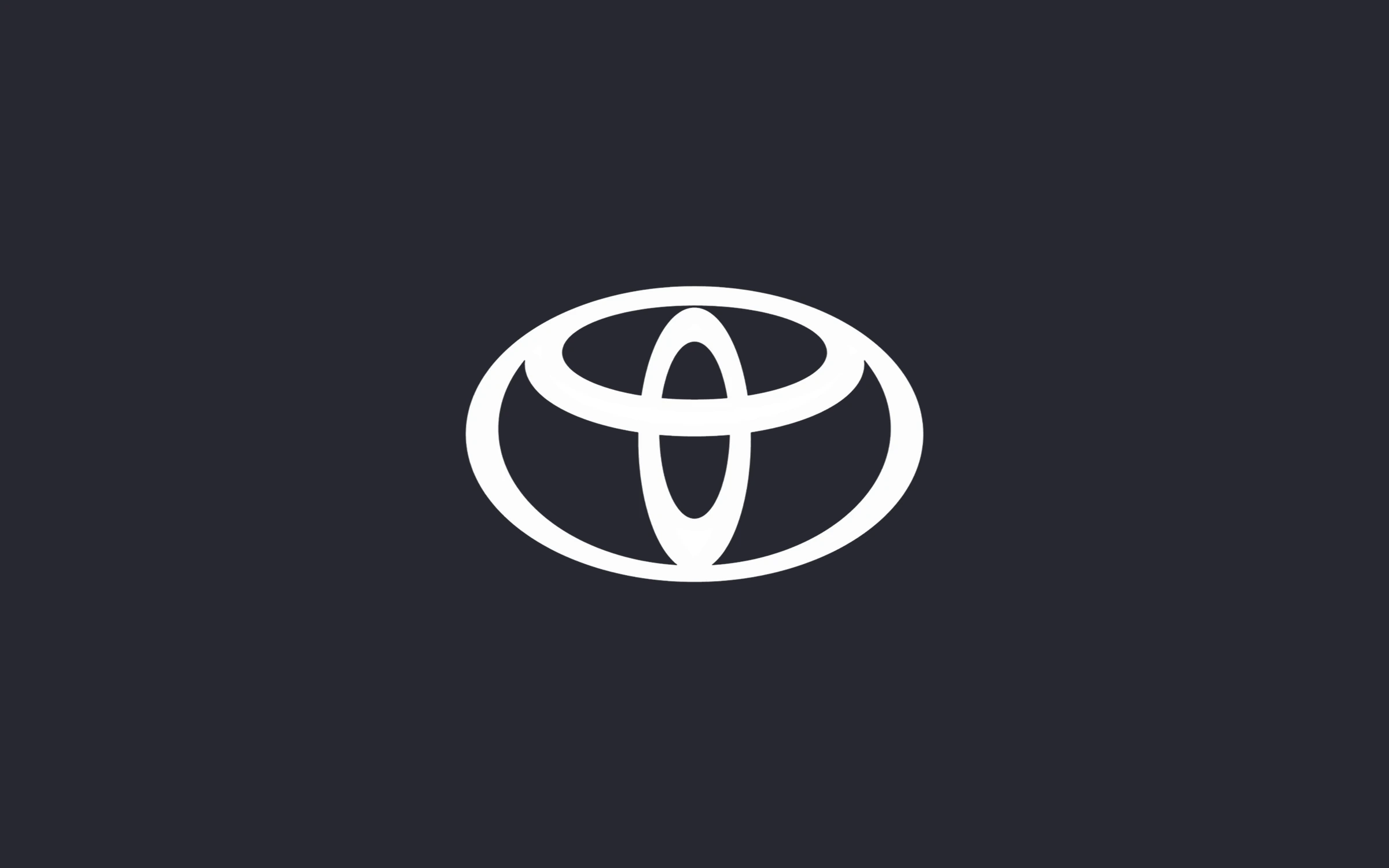 The Toyota emblem in white on a dark ground